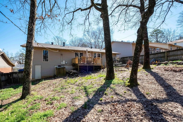 back of property featuring a deck and a fenced backyard