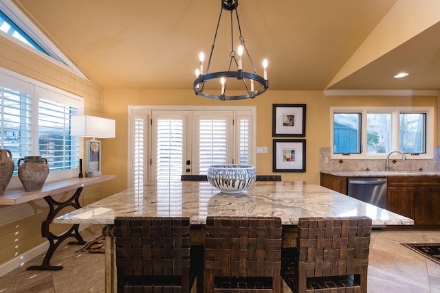 dining area with vaulted ceiling, a notable chandelier, recessed lighting, and light tile patterned floors