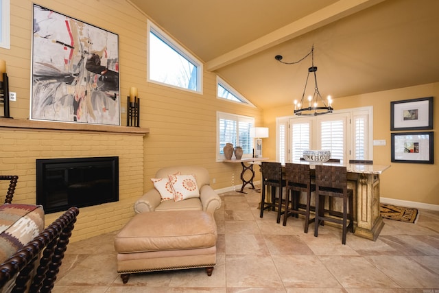 dining space with wooden walls, baseboards, an inviting chandelier, lofted ceiling with beams, and a fireplace