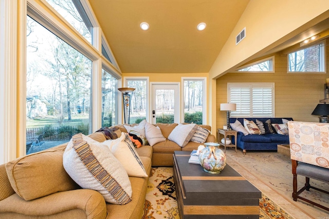 living area featuring vaulted ceiling, recessed lighting, and visible vents