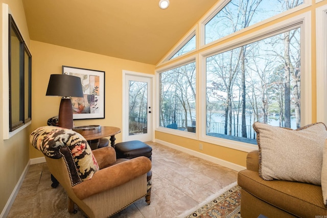 sunroom featuring a healthy amount of sunlight and vaulted ceiling