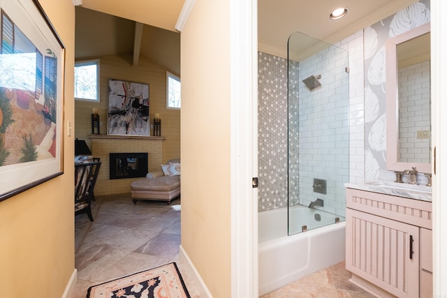 full bath with baseboards, a brick fireplace, vanity, and  shower combination