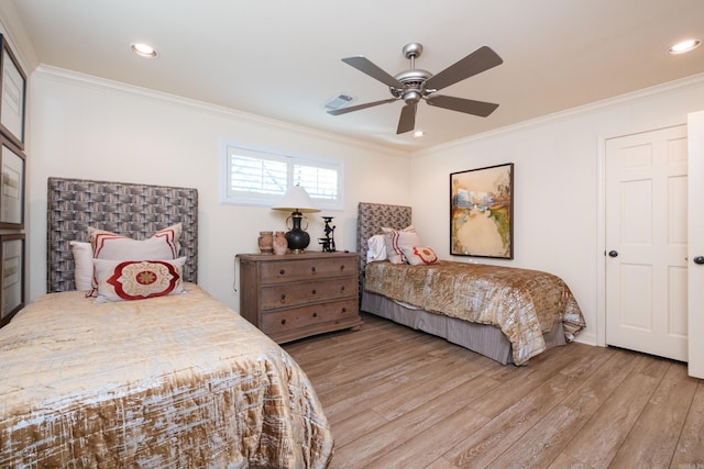 bedroom with crown molding, recessed lighting, visible vents, and light wood finished floors