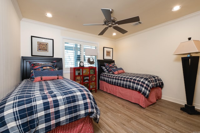 bedroom featuring recessed lighting, wood finished floors, visible vents, and ornamental molding