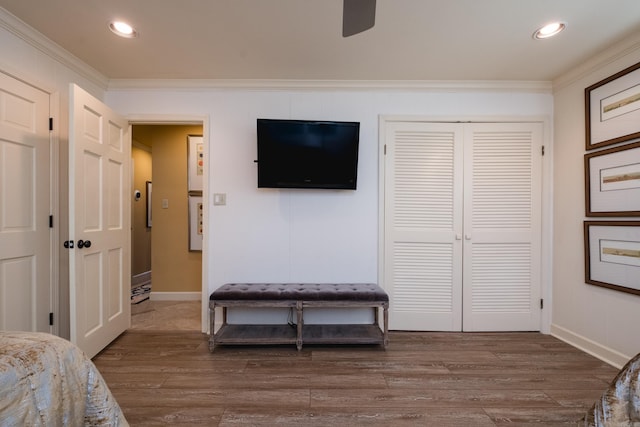 bedroom featuring recessed lighting, a closet, ornamental molding, and dark wood-style flooring