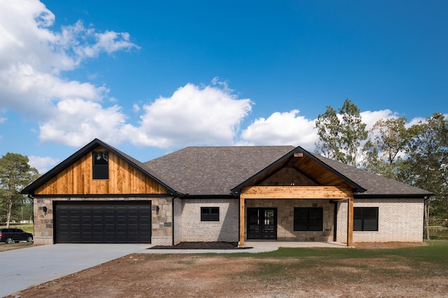 view of front facade with brick siding, a front lawn, roof with shingles, a garage, and driveway