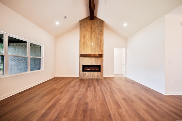 unfurnished living room featuring beamed ceiling, light wood-style flooring, a large fireplace, and visible vents