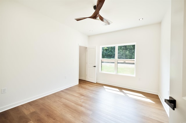 empty room featuring recessed lighting, baseboards, light wood-type flooring, and ceiling fan