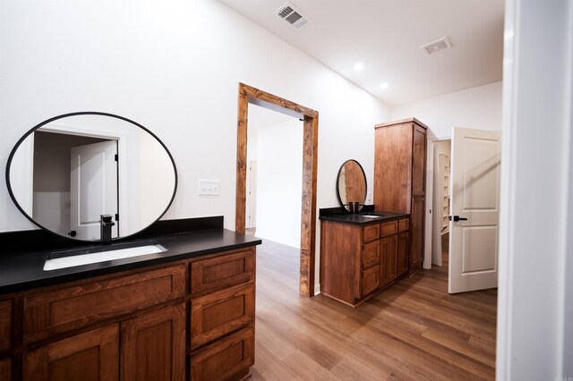 bathroom featuring vanity, recessed lighting, wood finished floors, and visible vents