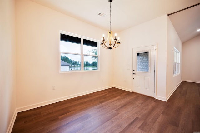 interior space featuring dark wood-style floors, visible vents, baseboards, lofted ceiling, and a chandelier