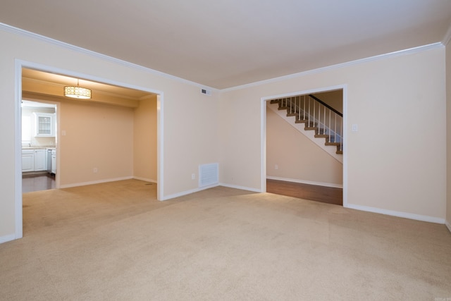 spare room with light carpet, visible vents, and ornamental molding