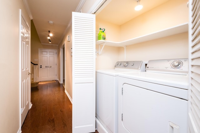 washroom featuring washer and clothes dryer, laundry area, dark wood-style floors, and ornamental molding