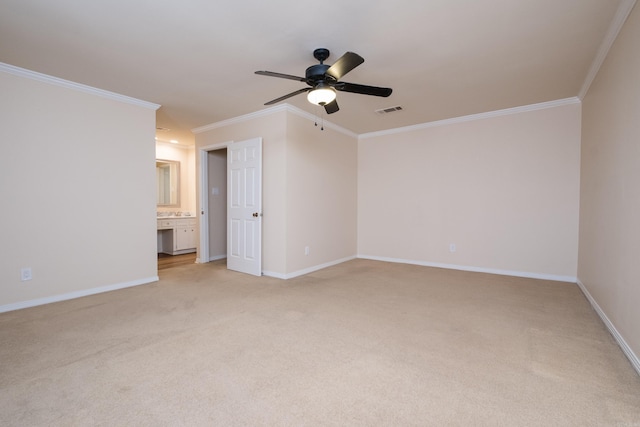 empty room with visible vents, baseboards, light colored carpet, and crown molding