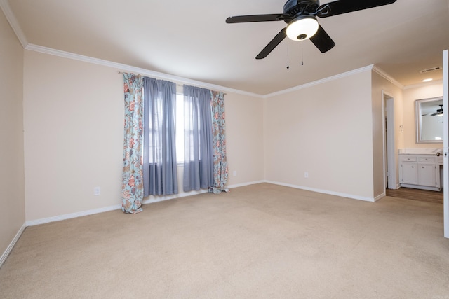 empty room with visible vents, light carpet, baseboards, and crown molding