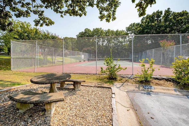 view of tennis court featuring fence