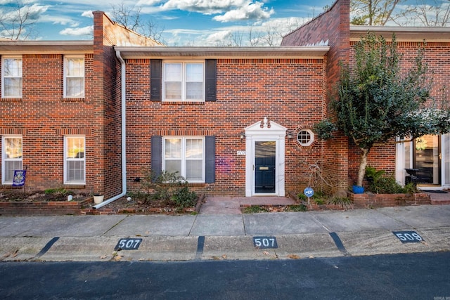 townhome / multi-family property with brick siding