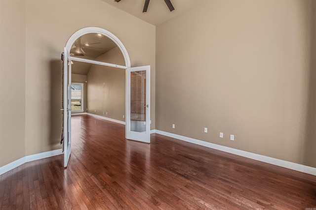 unfurnished room with hardwood / wood-style floors, baseboards, high vaulted ceiling, ceiling fan, and french doors