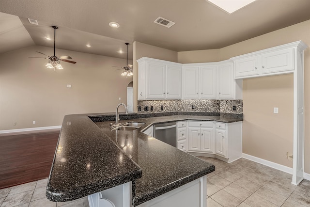 kitchen featuring light tile patterned floors, a sink, white cabinetry, and stainless steel dishwasher