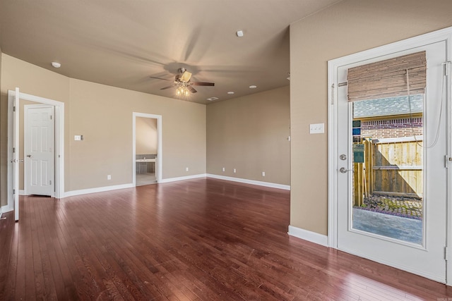 unfurnished room with dark wood finished floors, baseboards, and ceiling fan