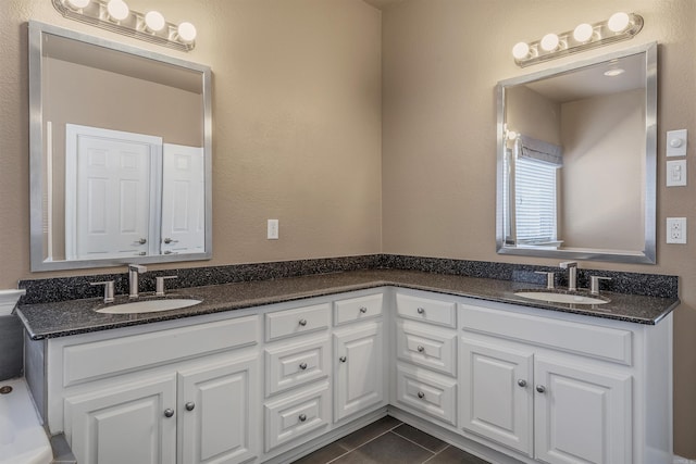 full bathroom with tile patterned flooring, double vanity, and a sink