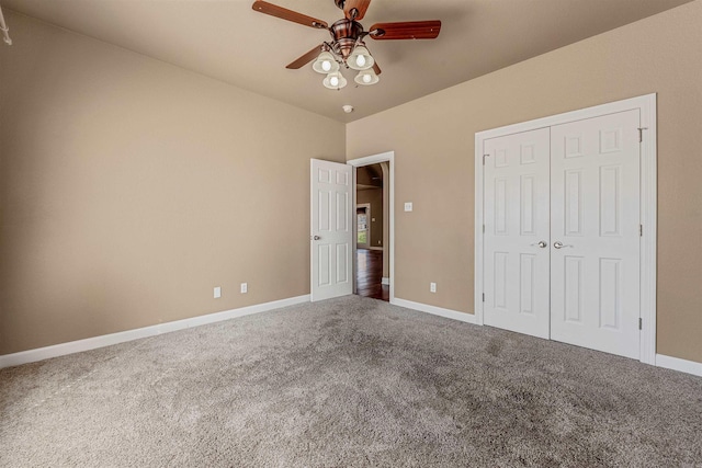 unfurnished bedroom with a closet, baseboards, carpet, and a ceiling fan