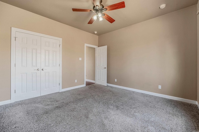 unfurnished bedroom featuring a closet, baseboards, and carpet