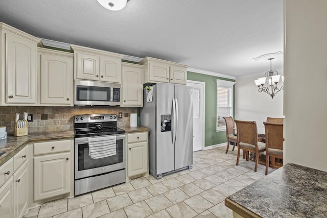 kitchen with cream cabinetry, tasteful backsplash, dark countertops, stainless steel appliances, and crown molding