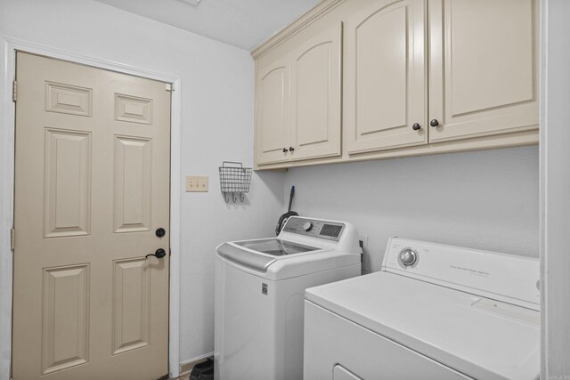 clothes washing area with cabinet space and washing machine and clothes dryer