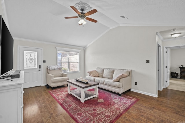 living area with visible vents, a ceiling fan, dark wood-style floors, crown molding, and vaulted ceiling