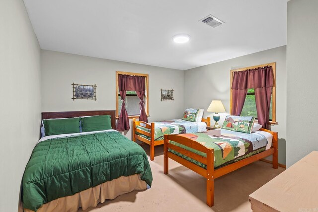 bedroom with visible vents and carpet flooring