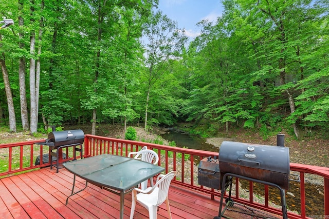 wooden deck with a grill