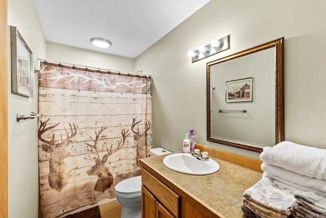 bathroom with a shower with shower curtain, toilet, and vanity