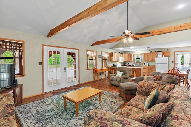 living area with a ceiling fan, lofted ceiling with beams, wood finished floors, french doors, and baseboards