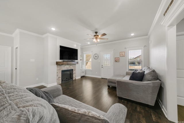 living room with a glass covered fireplace, dark wood-type flooring, crown molding, and baseboards