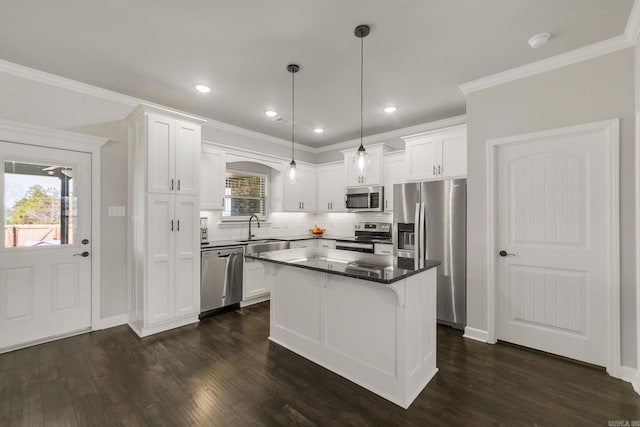 kitchen featuring a sink, white cabinetry, stainless steel appliances, decorative backsplash, and dark wood-style flooring