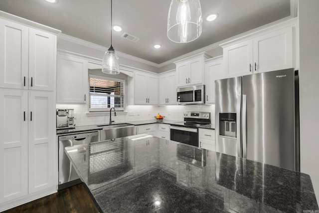 kitchen with visible vents, white cabinets, appliances with stainless steel finishes, and a sink