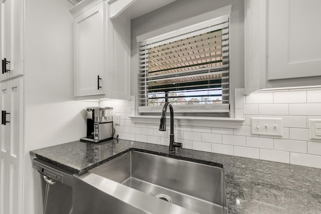 kitchen with dishwasher, tasteful backsplash, white cabinetry, and a sink