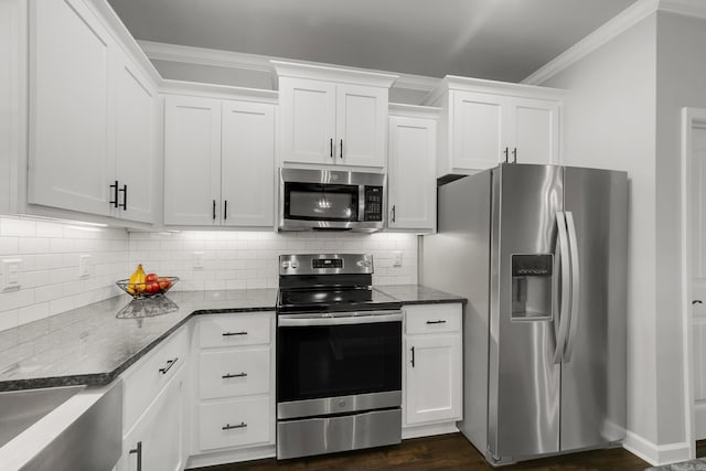 kitchen featuring decorative backsplash, dark stone countertops, stainless steel appliances, and crown molding