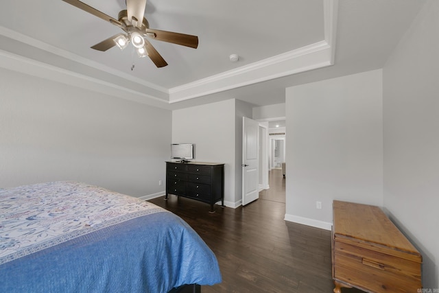 bedroom with baseboards, a ceiling fan, a tray ceiling, and dark wood-style flooring