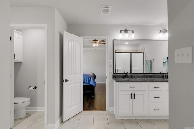 bathroom with tile patterned floors, visible vents, toilet, and a stall shower