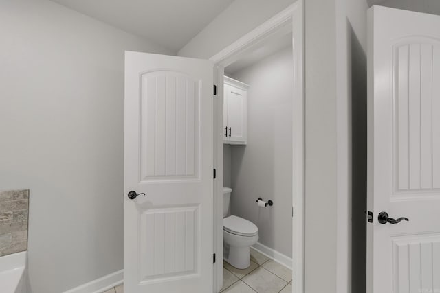 bathroom with tile patterned floors, toilet, and baseboards