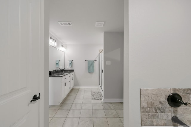 full bath featuring tile patterned flooring, visible vents, a shower stall, double vanity, and a sink