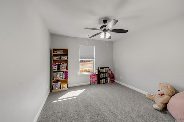 playroom with a ceiling fan, baseboards, and carpet floors