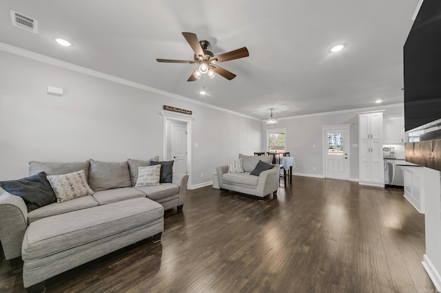 living area with dark wood-style floors, visible vents, crown molding, and baseboards