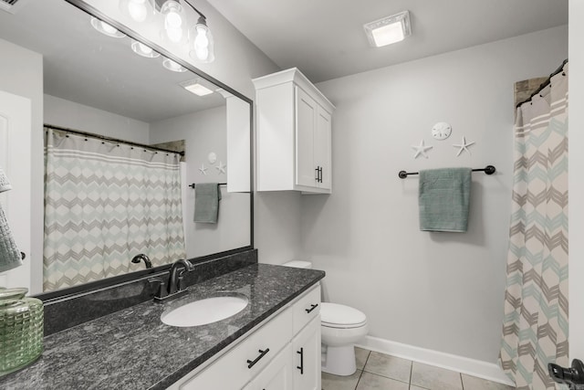 bathroom featuring vanity, tile patterned floors, toilet, and baseboards