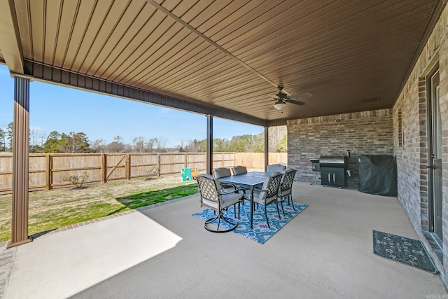 view of patio / terrace featuring a fenced backyard, outdoor dining space, ceiling fan, and grilling area