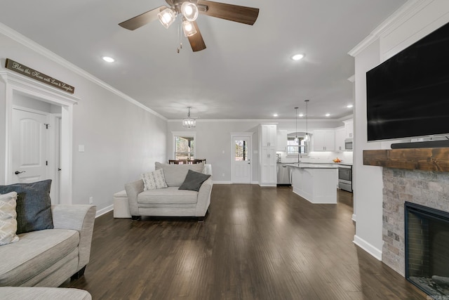 living room featuring baseboards, dark wood-type flooring, a fireplace, and crown molding