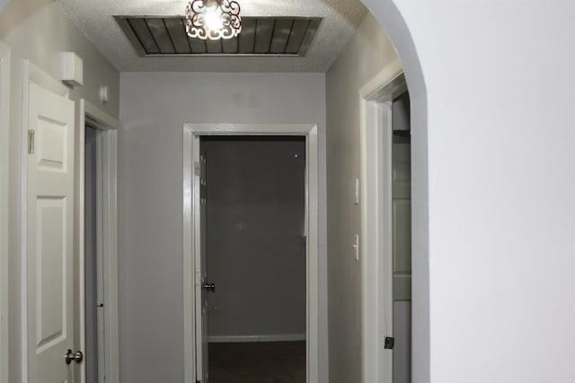 hallway with arched walkways and visible vents