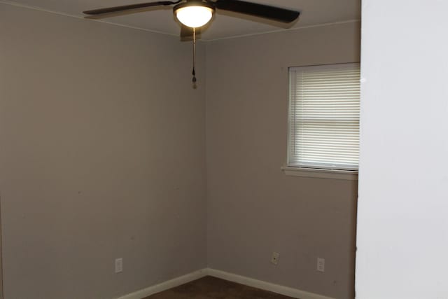 unfurnished room with baseboards and ceiling fan