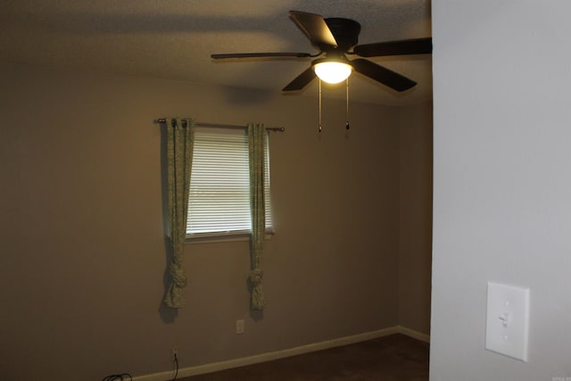 unfurnished room with baseboards and ceiling fan